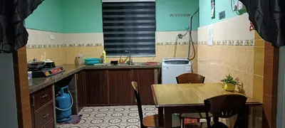 a small kitchen with a table and a sink at RUMAH INAP BANDAR PERDANA in Sungai Petani