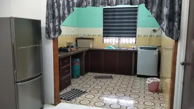 a kitchen with a sink and a refrigerator at RUMAH INAP BANDAR PERDANA in Sungai Petani