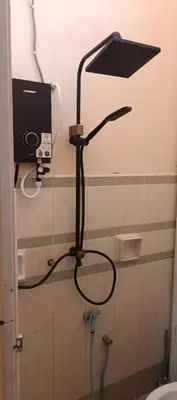 a shower head in a bathroom with a toilet at RUMAH INAP BANDAR PERDANA in Sungai Petani