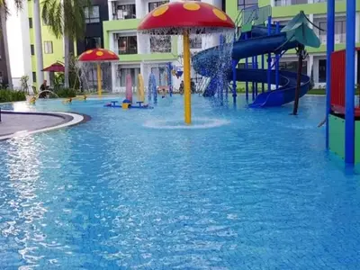 a water park with a water slide in a pool at Razads Waterpark Homestay Ipoh in Ipoh