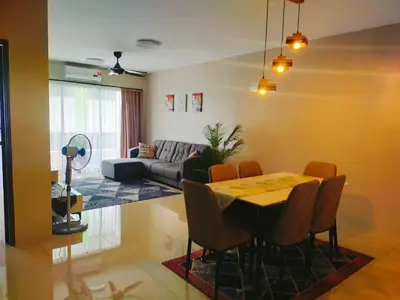 a living room with a table and a couch at Razads Waterpark Homestay Ipoh in Ipoh