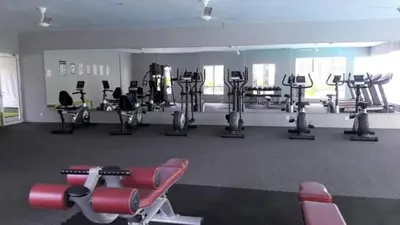 a gym with lots of exercise equipment in a room at Razads Waterpark Homestay Ipoh in Ipoh