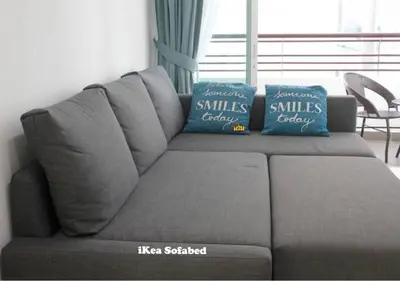 two blue pillows sitting on top of a couch at H2H - Holland Cottage - Majestic Ipoh - 7pax in Ipoh