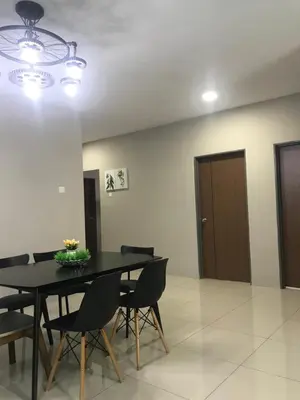 a dining room with a black table and chairs at Ipoh Manhattan TSL Pool View Water Park Homestay! in Kampong Pinji