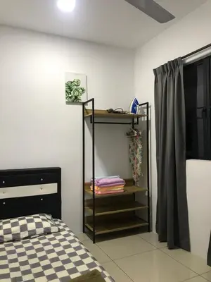 a bedroom with a bed and a shelf with towels at Ipoh Manhattan TSL Pool View Water Park Homestay! in Kampong Pinji