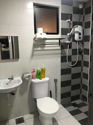 a bathroom with a toilet and a sink at Ipoh Manhattan TSL Pool View Water Park Homestay! in Kampong Pinji