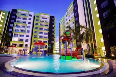 a large pool with a playground in front of some buildings at Ipoh Manhattan TSL Pool View Water Park Homestay! in Kampong Pinji
