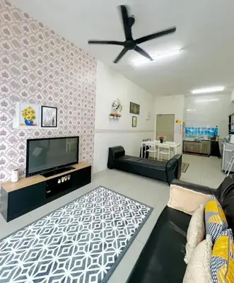 a living room with a tv and a ceiling fan at Deq Noor Homestay in Cameron Highlands