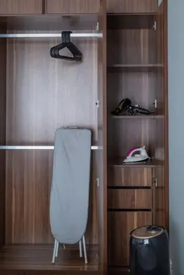 a closet with a white chair and a phone at Deluxe Seaview Suite Twin Bed by The Only Bnb in Tanjong Tokong