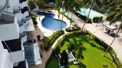 an aerial view of a swimming pool at a resort at Susies Deluxe Seaview Suite Sri Sayang in Batu Ferringhi