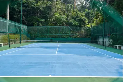 a tennis court with a tennis racket on it at Susies Deluxe Seaview Suite Sri Sayang in Batu Ferringhi