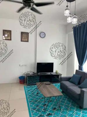 a living room with a couch and a ceiling fan at TIARA @ CASA KAYANGAN (MUSLIM HOMESTAY) in Ipoh