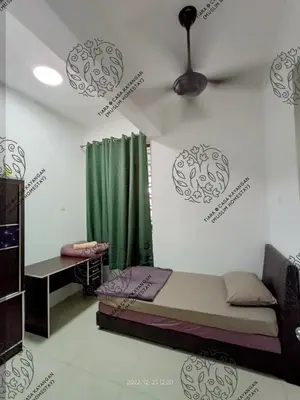 a bedroom with a bed and a green curtain at TIARA @ CASA KAYANGAN (MUSLIM HOMESTAY) in Ipoh