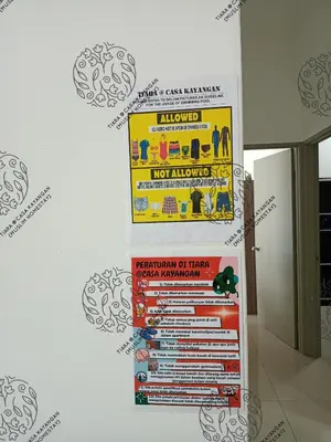 a poster on a wall in a room at TIARA @ CASA KAYANGAN (MUSLIM HOMESTAY) in Ipoh