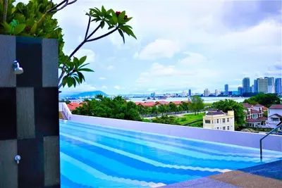 a swimming pool with a view of the city at \u5317\u6b27ING\u98ce\u683c\u8c6a\u534e\u65e5\u51fa\u6d77\u666f\u5957\u623f Nordic ING Luxury Seaview Suite in Tanjong Tokong