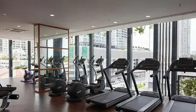 a gym with treadmills and ellipticals in a building at \u5317\u6b27ING\u98ce\u683c\u8c6a\u534e\u65e5\u51fa\u6d77\u666f\u5957\u623f Nordic ING Luxury Seaview Suite in Tanjong Tokong