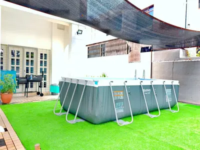 a stage on a lawn in a building withgrass at 527 BeachHouse l 5 bedroom with swimming pool - 3min walk to the beach in Tanjung Bungah