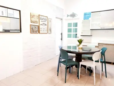 a kitchen and dining room with a table and chairs at 527 BeachHouse l 5 bedroom with swimming pool - 3min walk to the beach in Tanjung Bungah