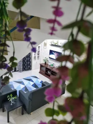 a living room with a couch and a tv at Ssue Klebang Ipoh Homestay With Complementary Pool & High Speed internet WIFI in Chemor