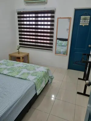 a bedroom with a bed and a blue door and a window at Ssue Klebang Ipoh Homestay With Complementary Pool & High Speed internet WIFI in Chemor