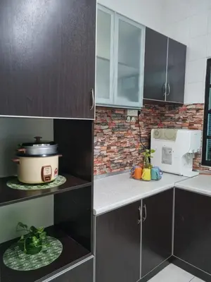 a kitchen with black cabinets and a counter with a microwave at Ssue Klebang Ipoh Homestay With Complementary Pool & High Speed internet WIFI in Chemor