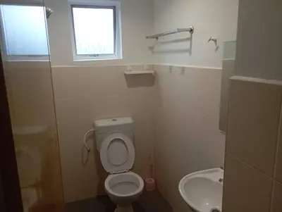 a small bathroom with a toilet and a sink at CH Budget Hotel in Cameron Highlands