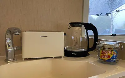 a toaster sitting on a kitchen counter next to a sink at Stellar GoldenHill Cameron in Tanah Rata