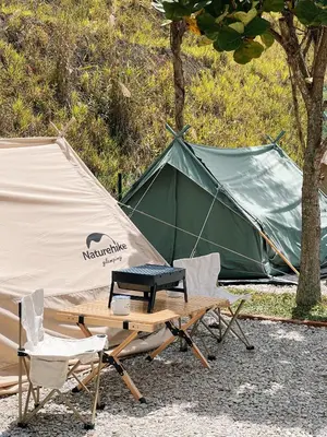 a tent and two chairs and a picnic table with a grill at Stellar GoldenHill Cameron in Tanah Rata