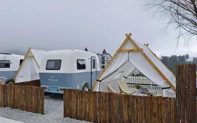 a couple of tents in front of a fence at Stellar GoldenHill Cameron in Tanah Rata