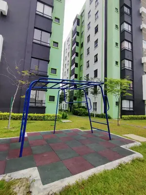 a blue metal object in a park with tall buildings at KT's Homestay- Corner Unit - Manhattan Ipoh Water Park- Station 18 in Ipoh