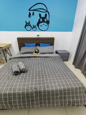 a bedroom with a bed with a cat on the wall at KT's Homestay- Corner Unit - Manhattan Ipoh Water Park- Station 18 in Ipoh