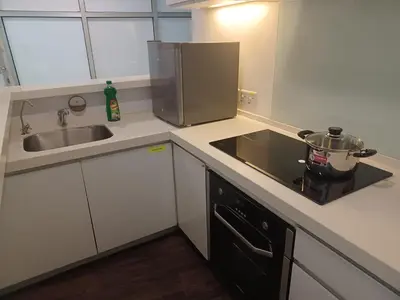 a kitchen with a sink and a stove top oven at SY Staycation - Apartment in Bayan Lepas