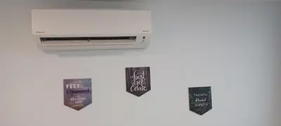 a shelf with a heater and two tags at SY Staycation - Apartment in Bayan Lepas