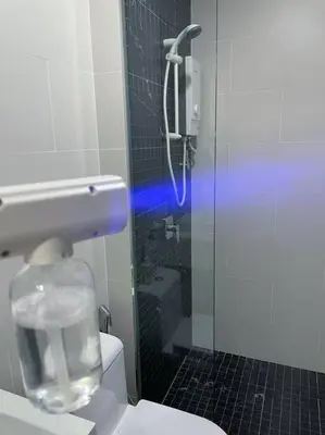 a bathroom with a shower and a toilet with a glass door at #12Georgetown Luxury Suite with Rooftop Pool in George Town