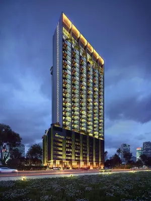 a tall building with lights on it at night at #12Georgetown Luxury Suite with Rooftop Pool in George Town
