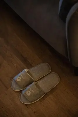 a pair of sandals sitting on a wooden floor at Elegant Seaview Projector Lounge by The Only Bnb in Tanjong Tokong