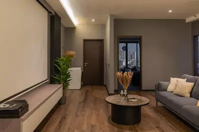 a living room with a couch and a table at Opulent Seaview Projector Lounge by The Only Bnb in Tanjong Tokong