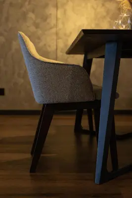 a blue chair sitting next to a table at Opulent Seaview Projector Lounge by The Only Bnb in Tanjong Tokong