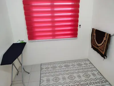 a red window in a white room with a tile floor at WAFID HOMESTAY SERI ISKANDAR in Seri Iskandar