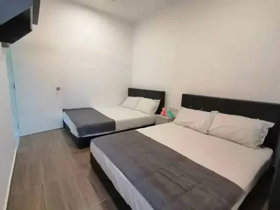 a hotel room with two beds and a bedskirts at Cameron top31 golden hills night market homestay in Brinchang