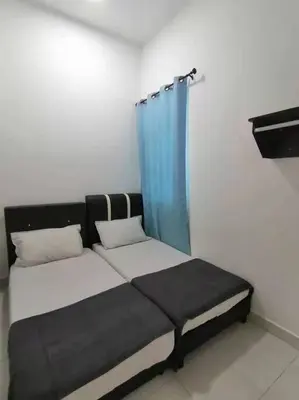a bed in a room with a blue curtain at Cameron top31 golden hills night market homestay in Brinchang