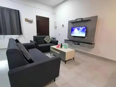 a living room with a couch and a tv at Cameron top31 golden hills night market homestay in Brinchang