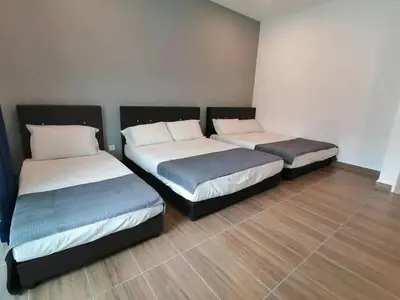 two beds sitting in a room with at Cameron top31 golden hills night market homestay in Brinchang