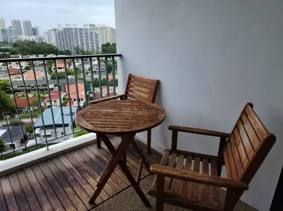 a table and two chairs on a balcony with a view at Deluxe Seaview Suite Twin Bed by The Only Bnb in Tanjong Tokong