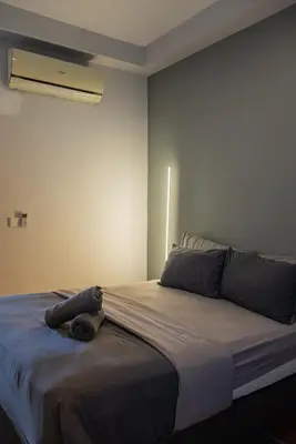 a bedroom with a bed with a blanket on it at Family Seaview Suite with 3 Rooms by The Only Bnb in Tanjong Tokong