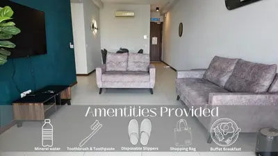 a living room with a couch and a chair at Family Seaview Suite with 3 Rooms by The Only Bnb in Tanjong Tokong
