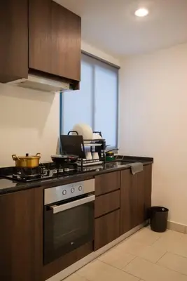 a kitchen with a stove and a counter top at Family Seaview Suite with 3 Rooms by The Only Bnb in Tanjong Tokong