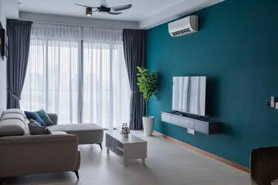 a living room with a couch and a tv at Family Seaview Suite with 3 Rooms by The Only Bnb in Tanjong Tokong