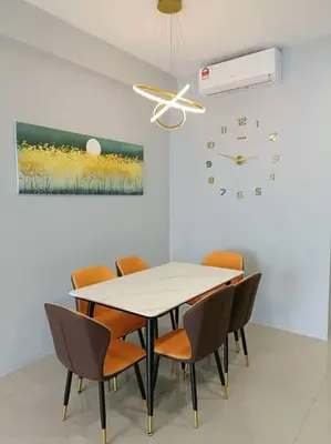 a dining room with a table and chairs and a clock at Ipoh The Cove Elegant Homestay Tambun in Ipoh