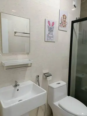 a white bathroom with a sink and a toilet at Ipoh The Cove Elegant Homestay Tambun in Ipoh